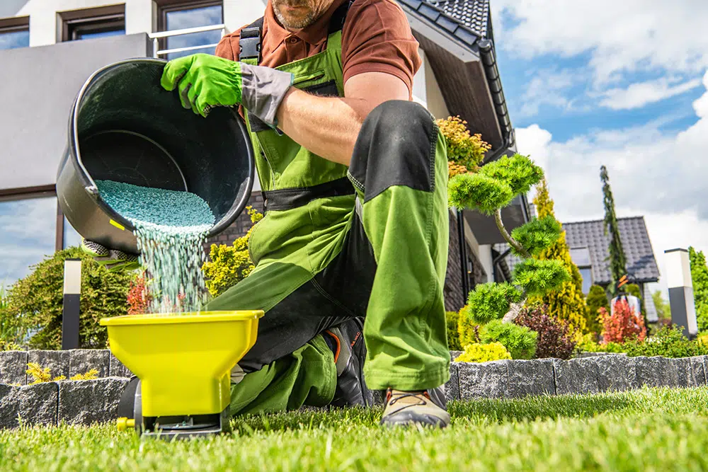 Professional applying fertilizer with specialized equipment